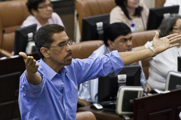 FILE - In this Jan. 28, 2014 file photo, opposition legislator Victor Hugo Tinoco, of the Sandinista Renewal Movement (MRS) gestures before the National Assembly votes to amend the Nicaraguan Constitution to include eliminating presidential term limits in Managua, Nicaragua. Nicaraguan police arrested Tinoco, the leader of the political movement Unamos, late Sunday, June 13, 2021, bringing to six the number detained over the weekend, the biggest one-day roundup so far in President Daniel Ortega’s campaign to jail anyone who might challenge his rule.  (AP Photo/Esteban Felix, File)