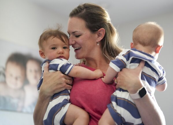 Amanda Visser holds her embryo-adopted six-month-old sons Collin and Jackson at her home, Monday, May 13, 2024, in Sterling, Colorado. When faced with infertility, Christians who believe life begins at or around conception wrestle with the ethics of IVF and how to build a family in a way that conforms with their beliefs. (AP Photo/Jack Dempsey)