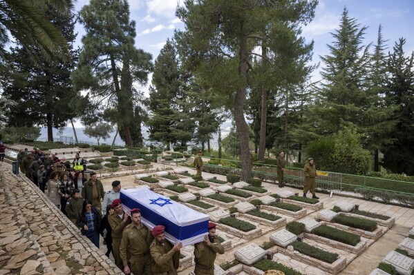 Israeli soldiers carry the flag-draped casket of reservist Gavriel Shani during his funeral at Mt. Herzl military cemetery in Jerusalem, Wednesday, Jan. 31, 2024. Shani, 28, was killed during Israel's ground operation in the Gaza Strip, where the Israeli army has been battling Palestinian militants in the war ignited by Hamas' Oct. 7 attack into Israel. (AP Photo/Ohad Zwigenberg)