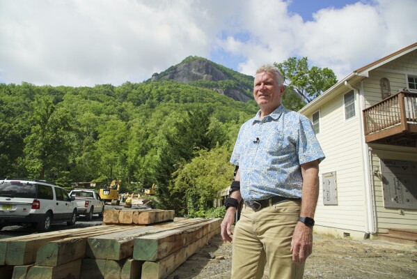 Mayor Peter O'Leary surveys work along Main Street in Chimney Rock Village, N.C., on Wednesday, May 14, 2025. (AP Photo/Allen G. Breed)
