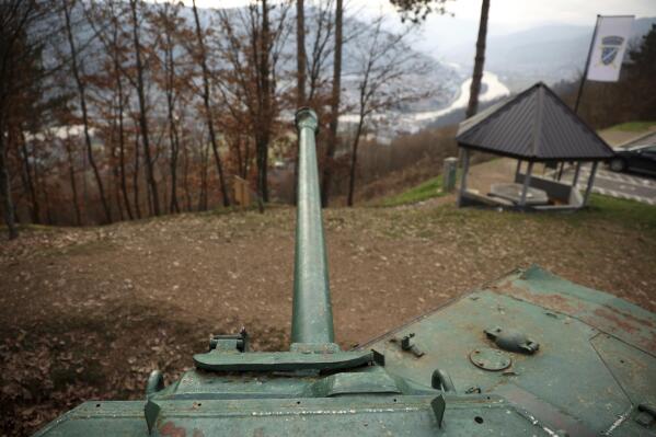 A tank is seen on a former frontline above Gorazde, Bosnia, Monday, Dec. 19, 2022. To survive and keep the lights on in their besieged town - cut off throughout Bosnia's 1992-95 interethnic war from access to electricity grid, food, medicine and the outside world - the people of Gorazde had to come up with various creative inventions. (AP Photo/Armin Durgut)