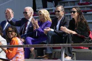President Joe Biden waves as he arrives to attend his granddaughter Maisy Biden's commencement ceremony at the University of Pennsylvania in Philadelphia, Monday, May 15, 2023. From right, President Biden's children Ashley Biden and Hunter Biden, and first lady Jill Biden. Social media users shared an altered video of the Biden family attending the commencement ceremony to add anti-Biden chants during the ceremony. (AP Photo/Patrick Semansky)