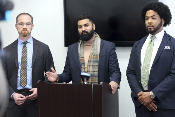 Athar Haseebullah, executive director of the ACLU of Nevada, responds to a question during a news conference at the ACLU of Nevada offices Friday, Jan. 19, 2024, in Las Vegas. With Haseebullah are Christopher Peterson, left, legal director of the ACLU of Nevada, and Quentin Savwoir, president of the Las Vegas branch of the NAACP. The news conference addressed questions relating to the release of Clark County School District Police body-worn camera footage depicting a CCSD police officer tackling and kneeling on a Black teen outside a Las Vegas high school last year. (Steve Marcus/Las Vegas Sun via AP)