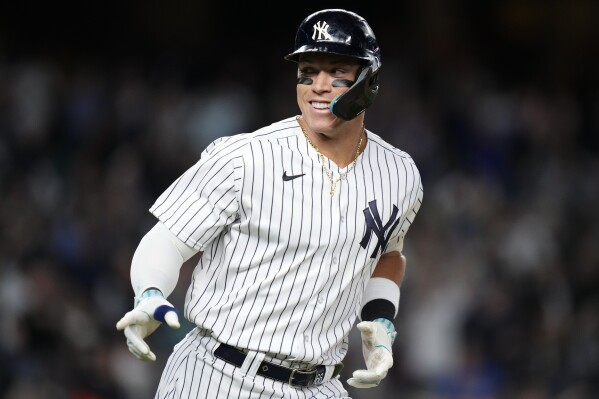 New York Yankees' Aaron Judge gestures to teammates after hitting a home run against the Arizona Diamondbacks during the seventh inning of a baseball game Friday, Sept. 22, 2023, in New York. (AP Photo/Frank Franklin II)