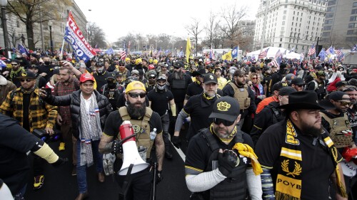 FILE - Supporters of President Donald Trump wearing attire associated with the Proud Boys attend a rally at Freedom Plaza, Dec. 12, 2020, in Washington. A judge on Friday, June 30, 2023, awarded more than $1 million to a Black church in downtown Washington, D.C. that sued the far-right Proud Boys for tearing down and burning a Black Lives Matter banner during a 2020 protest. (AP Photo/Luis M. Alvarez, File)