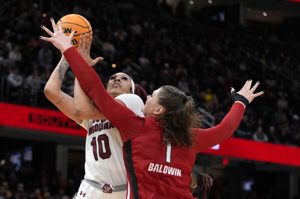 South Carolina center Kamilla Cardoso (10) shoots over North Carolina State center River Baldwin (1) during the first half of a Final Four college basketball game in the women's NCAA Tournament, Friday, April 5, 2024, in Cleveland. (AP Photo/Morry Gash)