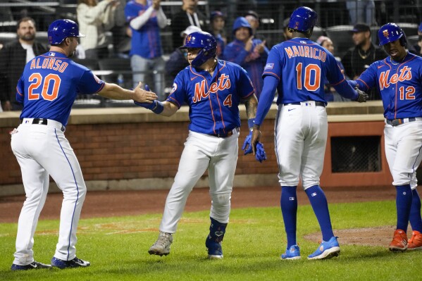 New York Mets' Francisco Alvarez (4) celebrates with Pete Alonso (20), Ronny Mauricio (10), and Francisco Lindor (12) after they scored off of Alvarez's grand slam during the third inning of the second game of a baseball doubleheader against the Philadelphia Phillies, Saturday, Sept. 30, 2023, in New York. (AP Photo/Mary Altaffer)