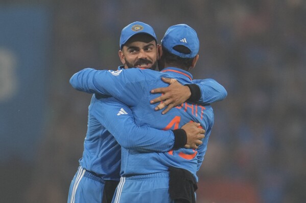 India's captain Rohit Sharma, right, greet India's Virat Kohli after India won their ICC Men's Cricket World Cup match against England in Lucknow, India, Sunday, Oct. 29, 2023.(AP Photo/Manish Swarup)