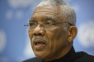 FILE - In this Sept. 28, 2015 file photo, Guyana's President David A. Granger delivers remarks during a press briefing at the United Nations headquarters. A lawmaker from the ruling coalition in Guyana voted late Friday, Dec. 21, 2018, with the opposition for a no-confidence motion, bringing down the administration of Granger and forcing fresh elections by March. (AP Photo/Kevin Hagen)
