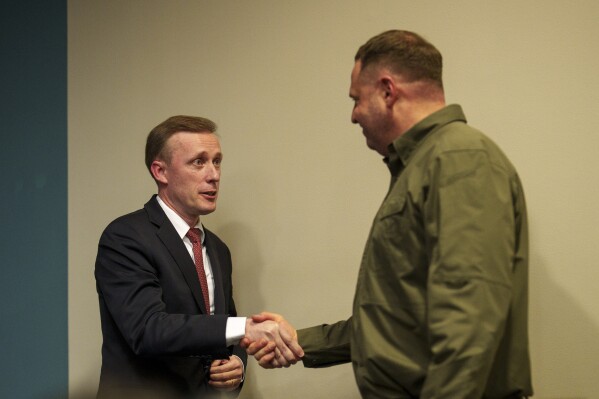 White House national security adviser Jake Sullivan, left, shakes hands with the head of the Office of the President of Ukraine Andriy Yermak, right, in Kyiv, Ukraine, Wednesday, March 20, 2024. (AP Photo/Vadim Ghirda)