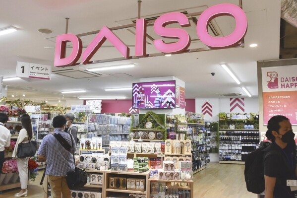 Shoppers visit a Daiso shop as the shop opened to the media in Tokyo, on April 13, 2022. Hirotake Yano, who founded the retail chain Daiso known for its 100-yen shops, Japan鈥檚 equivalent of the dollar store, has died. He was 80.(Kyodo News via AP)