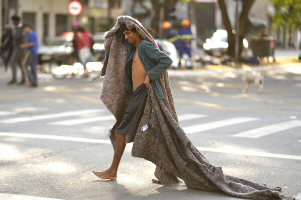FILE - A homeless man crosses a street in an area occupied by drug users known as Crackland, in downtown Sao Paulo, Brazil, May 11, 2023. The decline of Sao Paulo's downtown area has accelerated over the last year, where crack users are seen roaming the central streets of South America's biggest city. (AP Photo/Andre Penner, File)