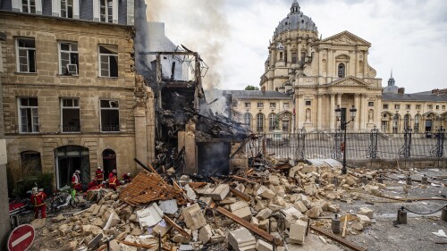 In this photo provided by the Paris Fire brigade on Thursday June 22, 2023, firefighters work at the site of an explosion in Paris, Wednesday, June 21, 2023. French rescue workers searched Thursday for a person feared missing after a powerful blast brought down a building on Paris' Left Bank, injuring more than 30 people, four of them critically. (E Thepault/BSPP via AP)