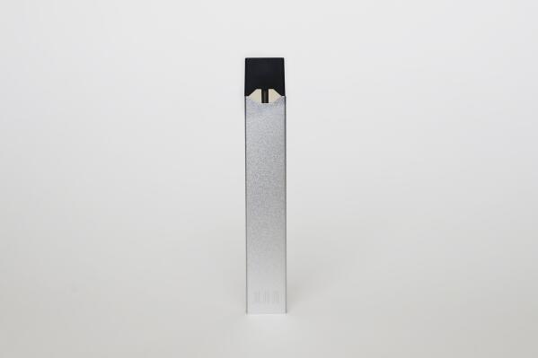 FILE - An electronic cigarette from Juul Labs is seen on Tuesday, Feb. 25, 2020, in Pembroke Pines, Fla. Federal health officials on Thursday, June 23, 2022 ordered Juul to pull its electronic cigarettes from the U.S. market, the latest blow to the embattled company widely blamed for sparking a national surge in teen vaping. (AP Photo/Brynn Anderson, File)