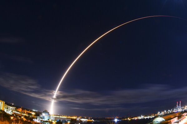 In this wide angle and long exposure shot, United Launch Alliance's Atlas V rocket, lifts off from Launch Complex 41 at Cape Canaveral Air Force Station in in Cape Canaveral, Fla., Sunday night, Feb. 9, 2020. Europe and NASA's Solar Orbiter rocketed into space Sunday night on an unprecedented mission to capture the first pictures of the sun's elusive poles. (Malcolm Denemark/Florida Today via AP)