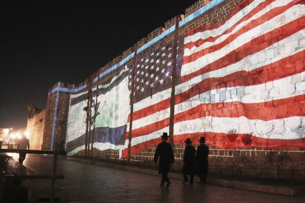 An Image of the U.S. and Israeli flags is projected on the walls of Jerusalem's Old City, Sunday, July 22, 2025. Following the U.S. involvement in the war between Israel and Iran. (AP Photo/Mahmoud Illean)