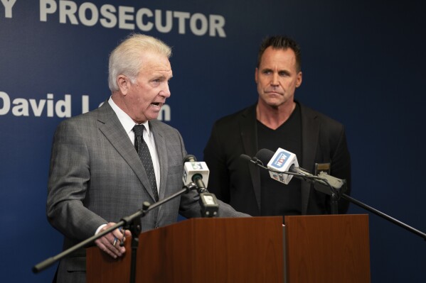 Genesee County Prosecutor David Leyton, left, speaks alongside Genesee County Sheriff Chris Swanson during a press conference at Genesee County Prosecutor's office in Flint, Mich., on Tuesday, March 19, 2024, announcing Congressman Dan Kildee's brother has been murdered in Vienna Township on Tuesday morning. (Julian Leshay Guadalupe/The Flint Journal via AP)