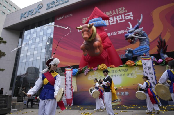 Dancers in traditional costumes perform to celebrate the opening for the Year 2024 trading outside of the Korea Exchange in Seoul, South Korea, Tuesday, Jan. 2, 2024. (AP Photo/Lee Jin-man)