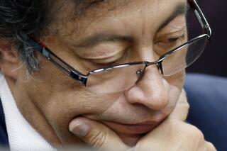 FILE - In this Dec. 4, 2018 file photo, Senator Gustavo Petro pauses during an interview at a local radio station in Bogota, Colombia. The former presidential candidate has adopted a low-key approach during the anti-government protests that started in late April 2021 ahead of his third run for Colombia’s presidency.  AP Photo/Fernando Vergara, File)