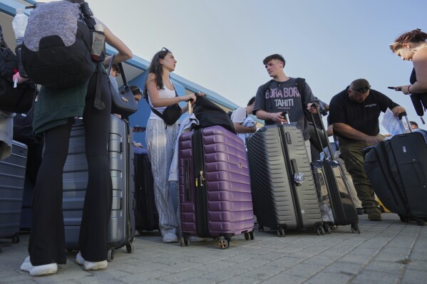 Evacuees from Israel arrive at the port of Larnaca, Cyprus, Wednesday, June 18, 2025. (AP Photo/Petros Karadjias)