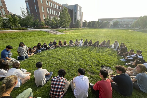 Participants in the Summer Science Program sit in a circle at Purdue University in West Lafayette, Ind., on July 21, 2023. SSP has puzzled over what do to with a surprise bequest of an estimated $200 million — about 100 times its annual budget. (Christin Latus, Summer Science Program via AP Photo)