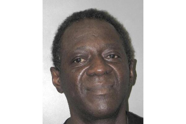 This Henderson Detention Center booking photo shows entertainer Flavor Flav following his arrest Oct. 4, 2021, in Henderson, Nev. Police and court documents said Tuesday, Oct. 19 the 62-year-old former hip-hop and reality TV star, whose legal name is William Jonathan Drayton Jr., faces a misdemeanor domestic battery charge stemming from a scuffle with his girlfriend at home. Drayton's lawyers say they'll explain his side of the story in court.  (Henderson Police Department via AP)