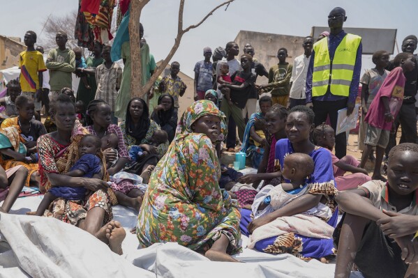 FILE - South Sudanese who fled from Sudan sit outside a nutrition clinic at a transit center in Renk, South Sudan, on May 16, 2023. Four Western countries have floated a proposal on Wednesday Oct. 4, 2023 for the U.N.'s top human rights body to appoint a team of experts to monitor and report on abuses and rights violations in war-wracked Sudan. (AP Photo/Sam Mednick, File)