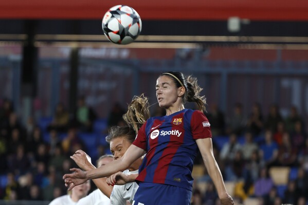 FILE - Barcelona's Aitana Bonmati heads the ball during the women's Champions League quarterfinals, second leg, soccer match between FC Barcelona and SK Brann Kvinner at the Estadi Johan Cruyff in Barcelona, Spain, Thursday, March 28, 2024. The Women’s Champions League semifinals kicking off Saturday, April 20, 2024 have a bit of everything. Defending champion Barcelona hosts Chelsea in their first-leg match before eight-time champion Lyon takes on French rival Paris Saint-Germain. (AP Photo/Joan Monfort, File)