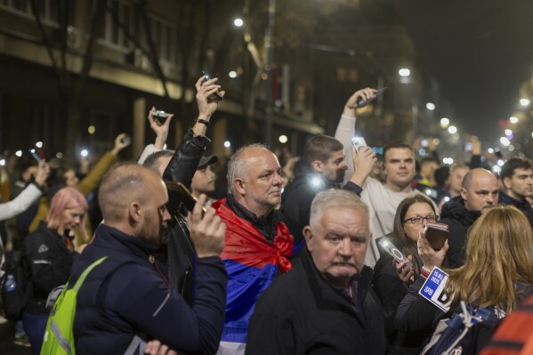 People observe 15 minutes of silence during a massive anti-government rally in Belgrade, Serbia, Saturday, March 15, 2025. (AP Photo/Marko Drobnjakovic)