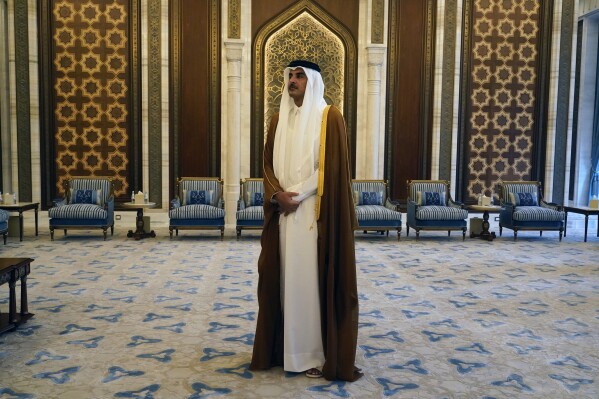 FILE - Qatari Emir Sheikh Tamim bin Hamad Al Thani waits for the arrival of U.S. Secretary of State Antony Blinken in Lusail, Qatar, Friday Oct. 13, 2023. On Friday, Oct. 20, The Associated Press reported on stories circulating online incorrectly claim that a video shows Qatar’s emir threatening to cut off the world’s natural gas supply if Israel doesn’t stop bombing Gaza. (AP Photo/Jacquelyn Martin, Pool, File)