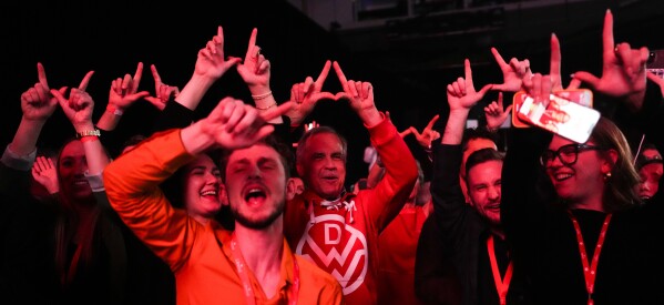 Canadian Prime Minister Mark Carney, center, dances to Canadian band Down With Webster as they play live at campaign headquarters after the Liberal Party won the Canadian election in Ottawa on Tuesday, April 29, 2025. (Sean Kilpatrick/The Canadian Press via AP)