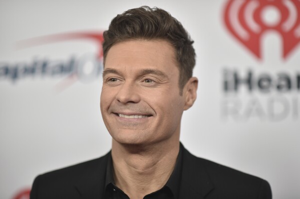 FILE - Ryan Seacrest arrives at the the 2021 Jingle Ball Los Angeles in Inglewood, Calif., on Dec. 3, 2021. Seacrest will usher in 2024 on “New Year’s Rockin’ Eve” from Times Square, with satellite locations in Los Angeles and San Juan, Puerto Rico. (Photo by Richard Shotwell/Invision/AP, File)