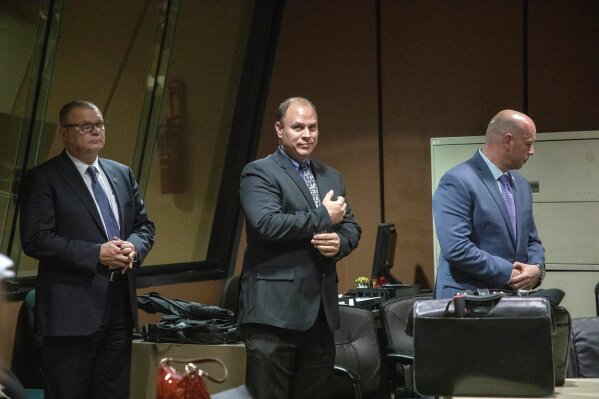 
              FILE - In this Oct. 30, 2018 file photo, from left, former Detective David March, Chicago Police Officer Thomas Gaffney and former officer Joseph Walsh appear at a pre-trial hearing at Leighton Criminal Court Building in Chicago. Prosecutors have laid out their case against the three Chicago police officers accused of participating in a cover-up of the fatal shooting of Laquan McDonald. The trial of officers charged with lying in their reports to protect Van Dyke is set to begin on Tuesday, Nov. 27, 2018. (Zbigniew Bzdak/Chicago Tribune via AP, Pool File)
            
