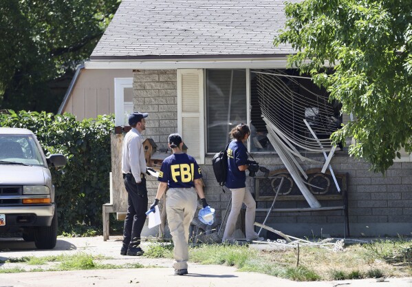 Law enforcement investigate the scene of a shooting involving the FBI Wednesday, Aug. 9, 2023 in Provo, Utah. A man accused of making threats against President Joe Biden was shot and killed by FBI agents hours before the president was expected to land in the state Wednesday, authorities said. (Laura Seitz/The Deseret News via AP)