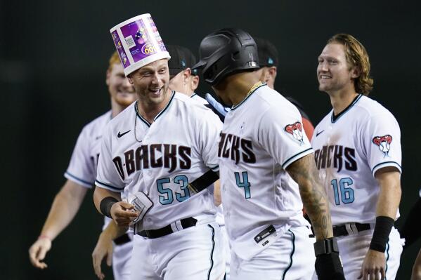Arizona Diamondbacks' Christian Walker (53) celebrates with Ketel Marte (4) and Jake Hager (16) after Walker grounder on which Josh Rojas scored the winning run against the San Diego Padres during the ninth inning of a baseball game Tuesday, June 28, 2022, in Phoenix. The Diamondbacks won 7-6. (AP Photo/Ross D. Franklin)