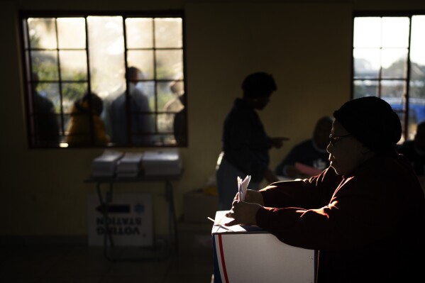 A woman casts her vote on Wednesday, May 29, 2024, during the general election in Kwamfana, South Africa.  South African voters cast their ballots in elections seen as the most important in their country in 30 years, an election that may put them in uncharted territory in the short history of their democracy, as the ANC's three-decade dominance has become the target of early elections.  A new generation of discontent in a country of 62 million people, half of whom are estimated to live in poverty.  (AP Photo/Emilio Morenatti)