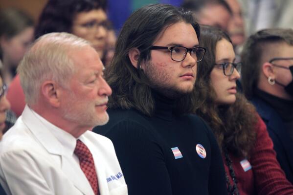 Adam Kellogg, center, a University of Kansas student and transgender man, follows a Kansas Senate health committee hearing on legislation aimed at preventing gender-affirming care for minors, Tuesday, Feb. 14, 2023, at the Statehouse in Topeka, Kan. The Republican-controlled Kansas Legislature is also considering a measure to define male and female in state law in such a way that it could prevent transgender men and women from changing their driver's licenses and birth certificates. (AP Photo/John Hanna)