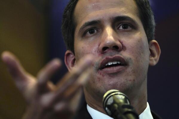 FILE - Opposition leader Juan Guaido explains the income and expenses of his self-proclaimed, parallel government in Caracas, Venezuela, Sept. 16, 2022. Venezuela’s opposition on Thursday, Jan. 5, 2023, has selected an all-female team of exiled former lawmakers to replace Guaido as the face of its efforts to remove socialist President Nicolas Maduro. (AP Photo/Ariana Cubillos, File)