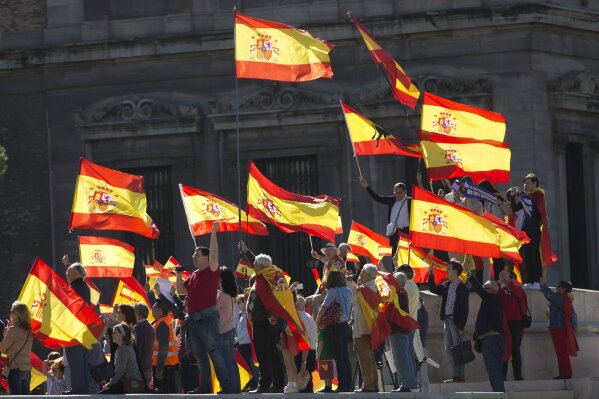 
              People wave Spanish flags during a mass protest by people angry with Catalonia's declaration of independence, in Madrid, Spain, Saturday, Oct. 28, 2017. Opponents of independence for Catalonia held the rally in the Spanish capital as thousands of people turned out in the Plaza de Colon. The rally comes after one of the country's most tumultuous days in decades. (AP Photo/Paul White)
            