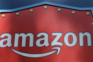 
              FILE - This Oct. 23, 2018, file photo shows an Amazon logo atop the Amazon Treasure Truck The Park DTLA office complex in downtown Los Angeles. Amazon has eclipsed Microsoft as the most valuable publicly traded company in the U.S. as a see-sawing stock market continues to reshuffle corporate America's pecking order. The shift occurred Monday, Jan. 7, 2019, after Amazon's shares rose 3 percent to close at $1,629.51 and lifted the e-commerce leader's market value to $797 billion. (AP Photo/Richard Vogel, File)
            