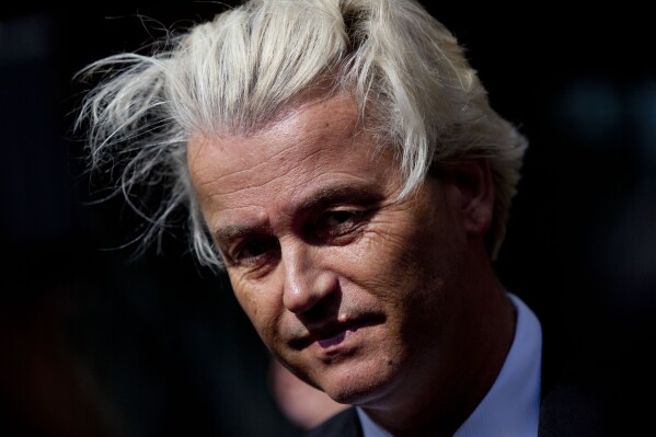 FILE - Dutch populist Geert Wilders pauses, as he speaks to journalists as he kicks off his European election campaign outside the Dutch National Bank, Monday, May 12, 2014, in Amsterdam, Netherlands. Geert Wilders has won a massive victory in a Dutch election and is in pole position to form the next governing coalition and possibly become the Netherlands' next prime minister. (AP Photo/Peter Dejong, File)