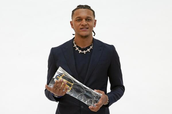 Orlando Magic forward Paolo Banchero poses with the Wilt Chamberlain Trophy after he was named basketball's 2022-23 NBA Rookie of the Year, Wednesday, April 26, 2023, in Orlando, Fla. (AP Photo/John Raoux)