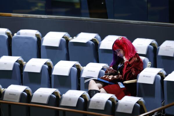 An attendee sits in the gallery during the 77th session of the United Nations General Assembly, at U.N. headquarters, Tuesday, Sept. 20, 2022. (AP Photo/Jason DeCrow)