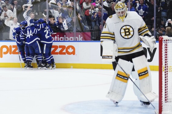 Toronto Maple Leafs players, back left, celebrate after William Nylander's goal as Boston Bruins goaltender Jeremy Swayman, right, looks on during second-period action in Game 6 of an NHL hockey Stanley Cup first-round playoff series in Toronto, Thursday, May 2, 2024. (Nathan Denette/The Canadian Press via AP)