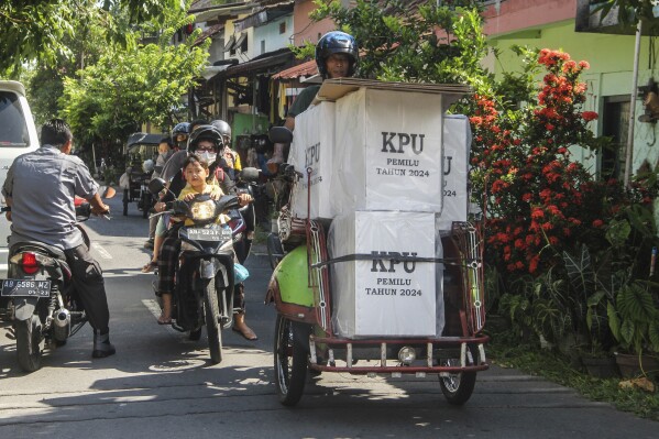 A man uses a motorized tricycle to transport ballot boxes to a polling station ahead of the Feb. 14 election in Yogyakarta, Indonesia, Tuesday, Feb. 13, 2024. Indonesia, the world's third-largest democracy, will open its polls on Wednesday to nearly 205 million eligible voters in presidential and legislative elections, the fifth since Southeast Asia's largest economy began democratic reforms in 1998. (AP Photo/Slamet Riyadi)