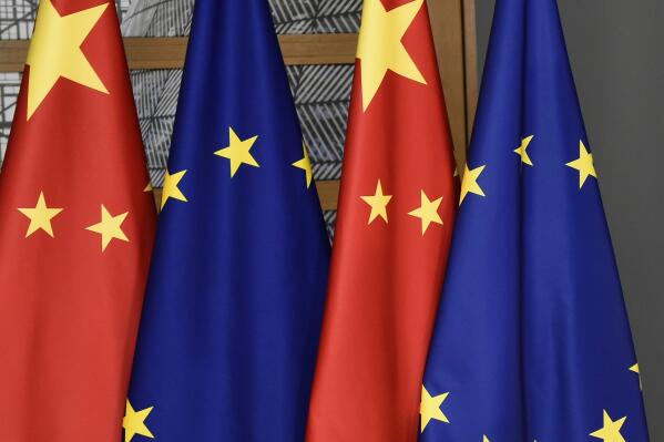 FILE - EU and Chinese flags are seen at the Europa building in Brussels, Tuesday, Dec. 17, 2019. The European Union will seek China's assurances that it won't assist Russia in circumventing economic sanctions leveled over the invasion of Ukraine at an annual summit Friday, April 1, 2022. (John Thys/Pool Photo via AP, File)