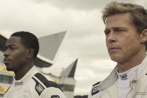 This image released by Warner Bros. Pictures shows Damson Idris, left, and Brad Pitt in a scene from "F1." (Warner Bros. Pictures via AP)