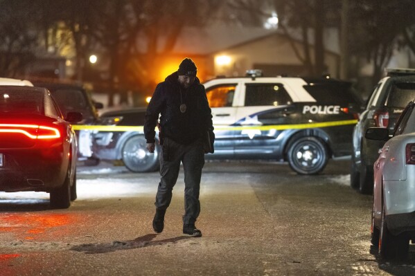 Police work a scene, Monday, Jan. 22, 2024, in Joliet, Ill., after multiple people were shot and killed over two days at three locations in the Chicago suburbs. (Tyler Pasciak LaRiviere/Chicago Sun-Times via AP)