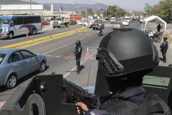 State police maintain a security checkpoint at the entrance of Chilpancingo, Mexico, Thursday, Feb. 15, 2024. Four Roman Catholic bishops met with Mexican drug cartel bosses in a bid to negotiate a possible peace accord, according to the Bishop of Chilpancingo-Chilapa, José de Jesús González Hernández. (AP Photo/Alejandrino Gonzalez)