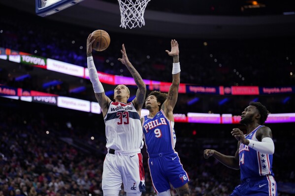 Washington Wizards' Kyle Kuzma (33) goes up for a shot against Philadelphia 76ers' Kelly Oubre Jr. (9) during the first half of an NBA basketball game, Monday, Nov. 6, 2023, in Philadelphia. (APPhoto/Matt Slocum)